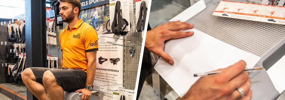 12GO Biking verkoper zit op apparaat om zitbotbreedte te bepalen en tekent deze vervolgens af op het papier met rondjes