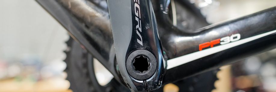 Ultegra crank-as van een zwarte fiets met PF30 logo erop