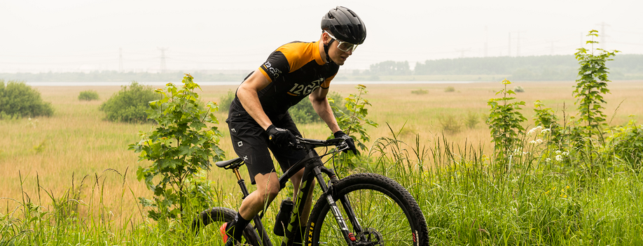 Fietser met veel gras op de achtergrond