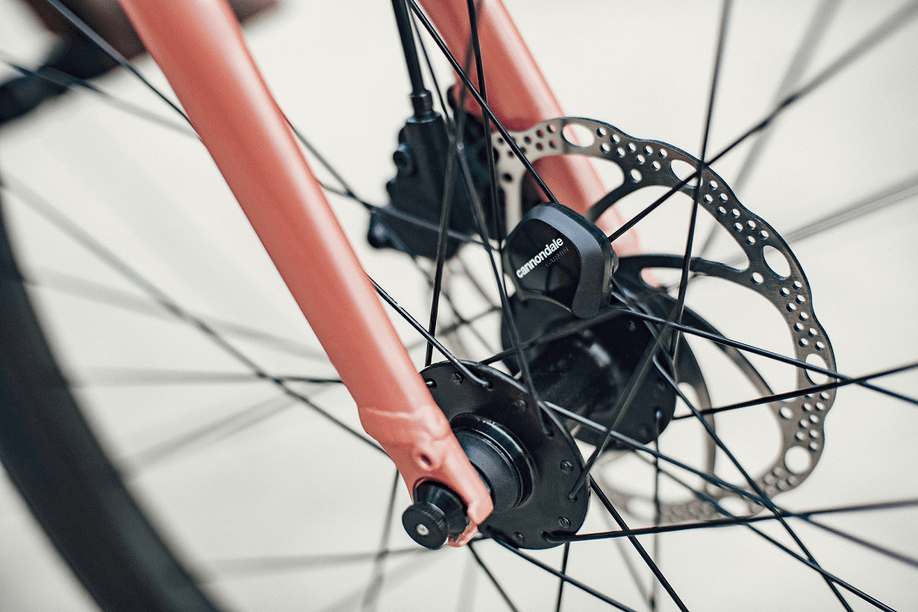 Cannondale sensor bevestigt aan een spaak van een fiets met schrijfremmen en roze frame