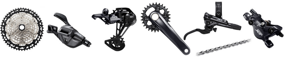 Onderdelen van Shimano XT; cassette, voorderailleur, achterderailleur, crankstel, ketting, shifter en remhendel