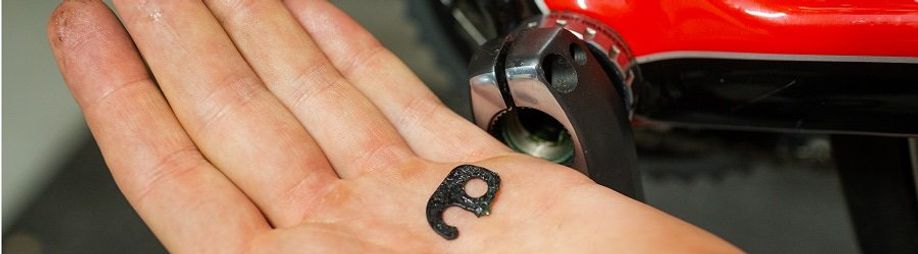 Persoon heeft borgpin van de crankarm in zijn hand liggen